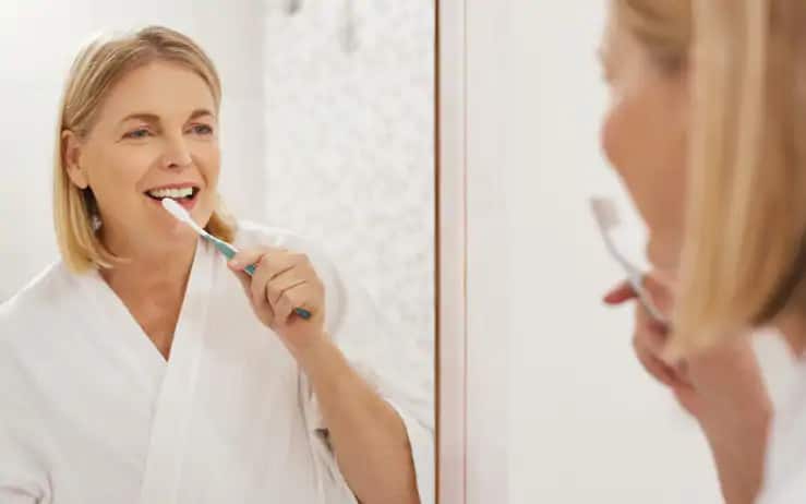 woman brushing her teeth